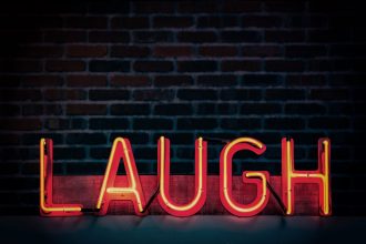image of neon sign saying laugh